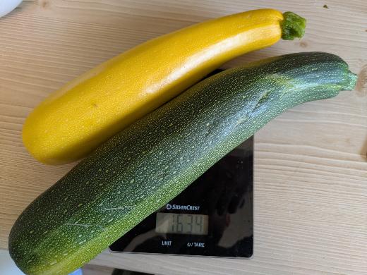 Yellow and green courgettes resting on a kitchen scale